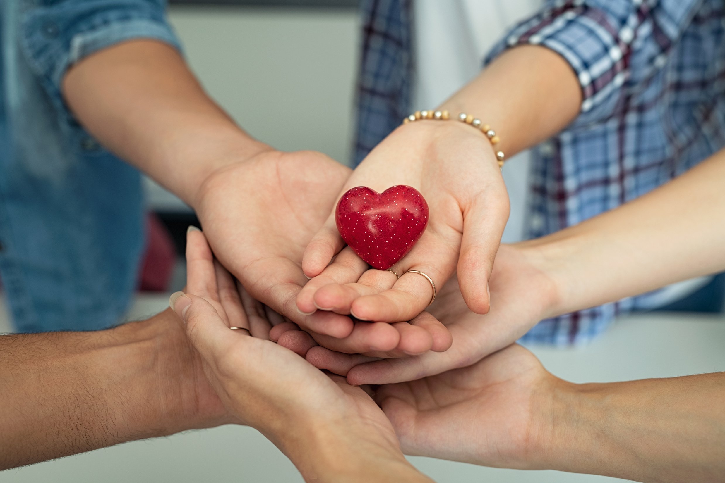 Hands Stacked Together with Heart on Top 